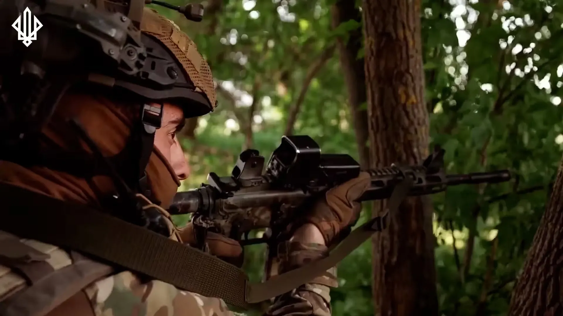 A soldier from the 3rd NGU Brigade in camouflage and a helmet takes aim with a rifle